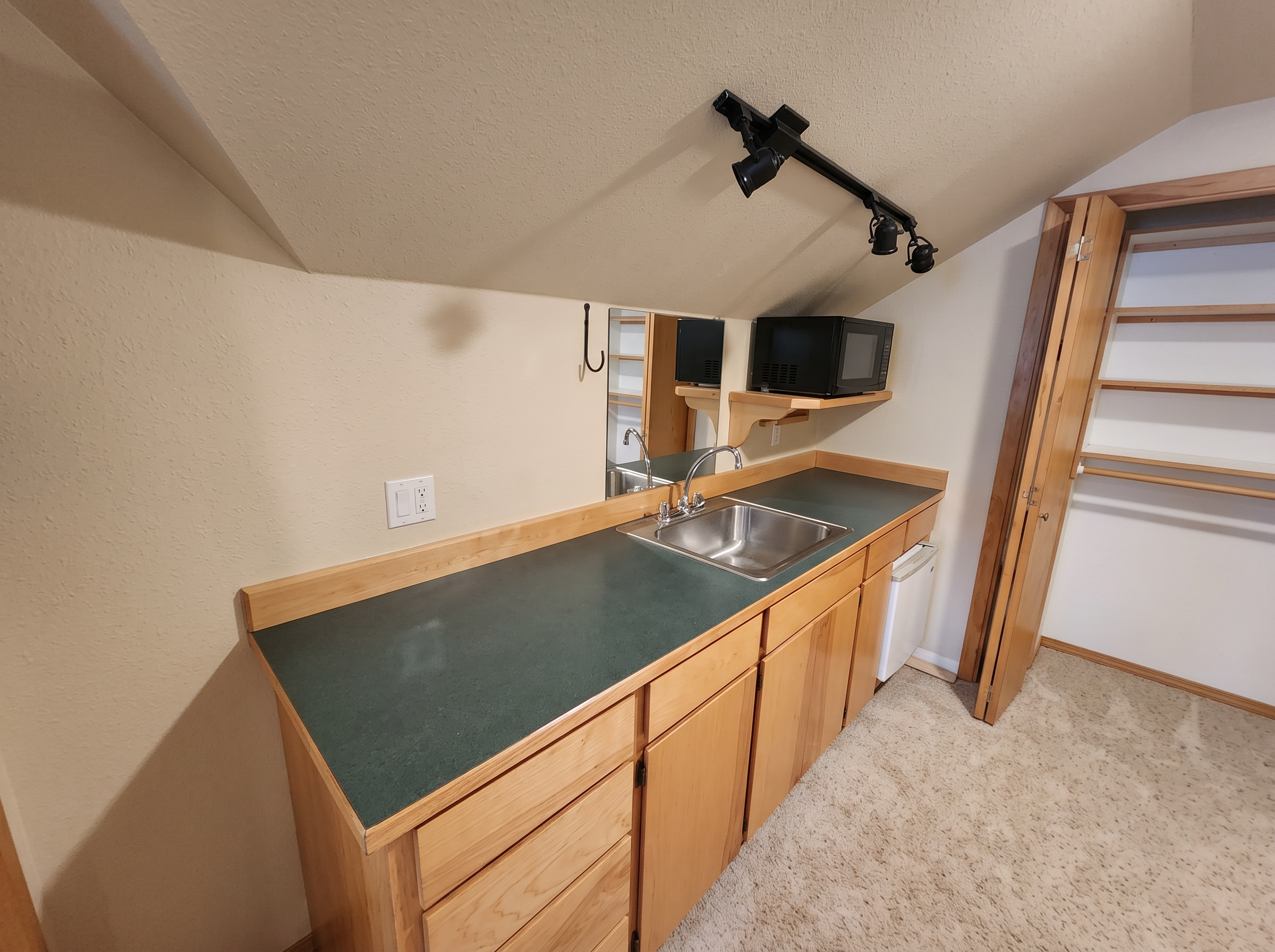 The apartment kitchenette, cleared and bright