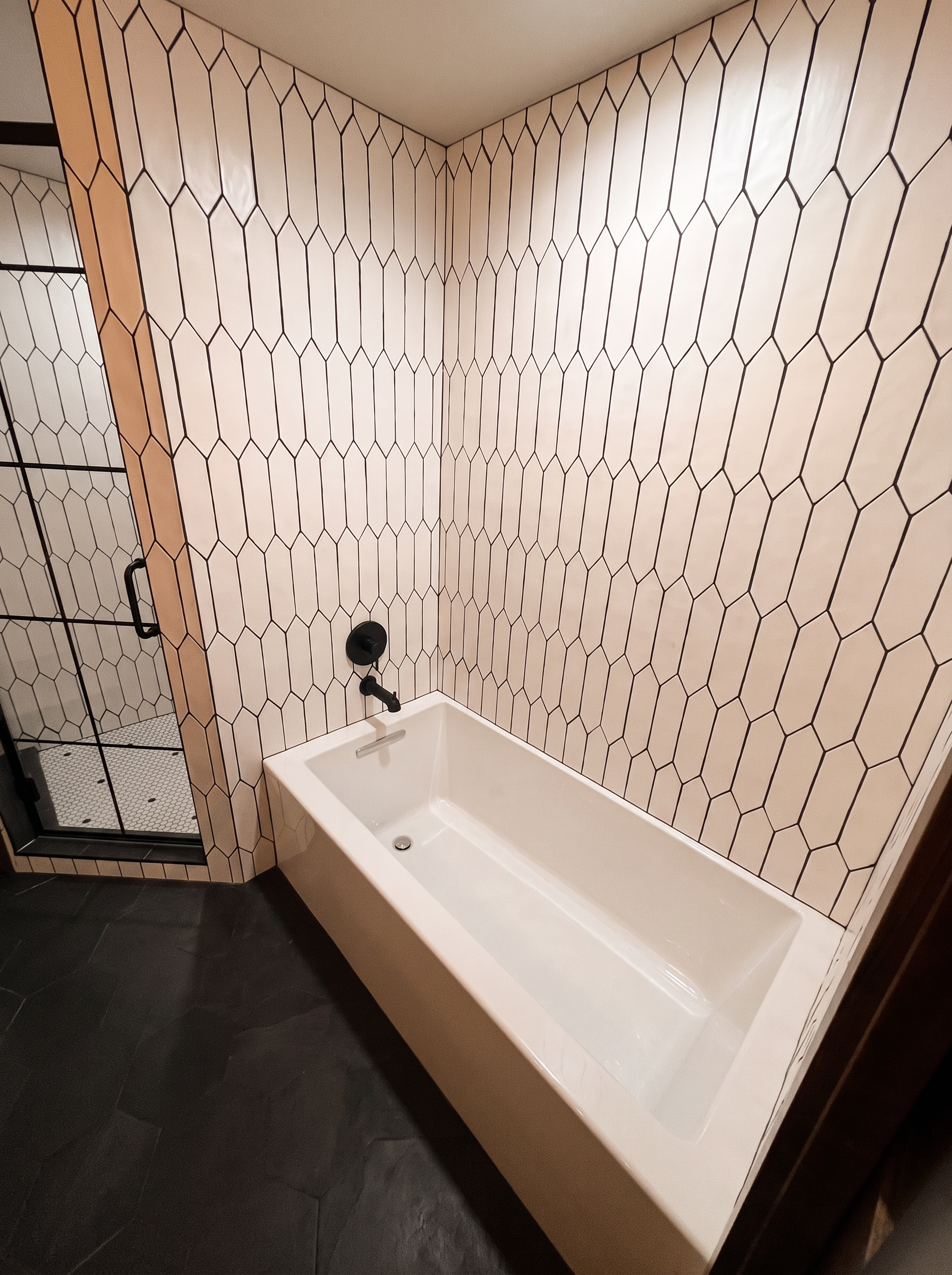 A white soaking tub set beneath a window