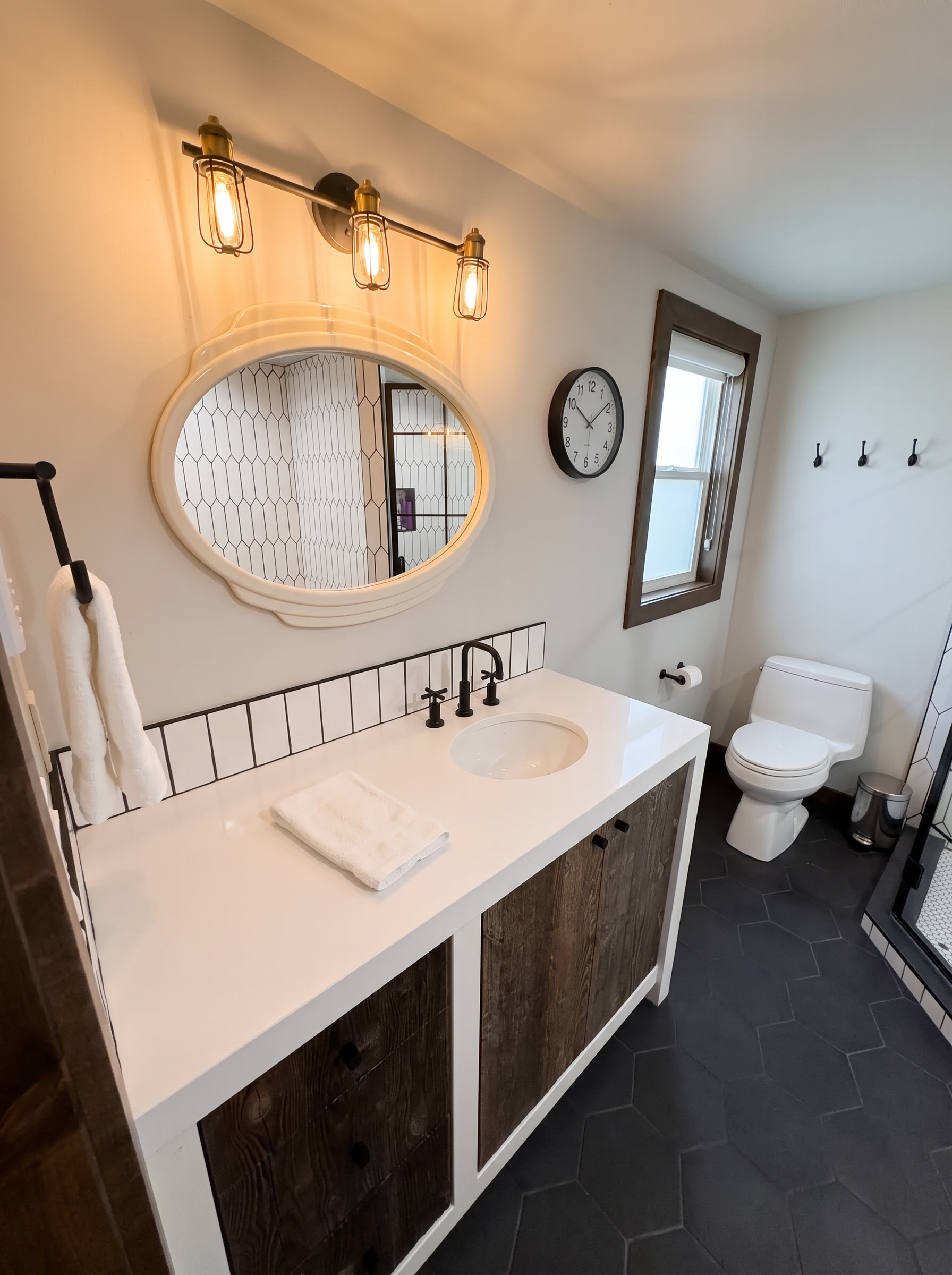 A guest bath vanity, cleared, with a framed mirror