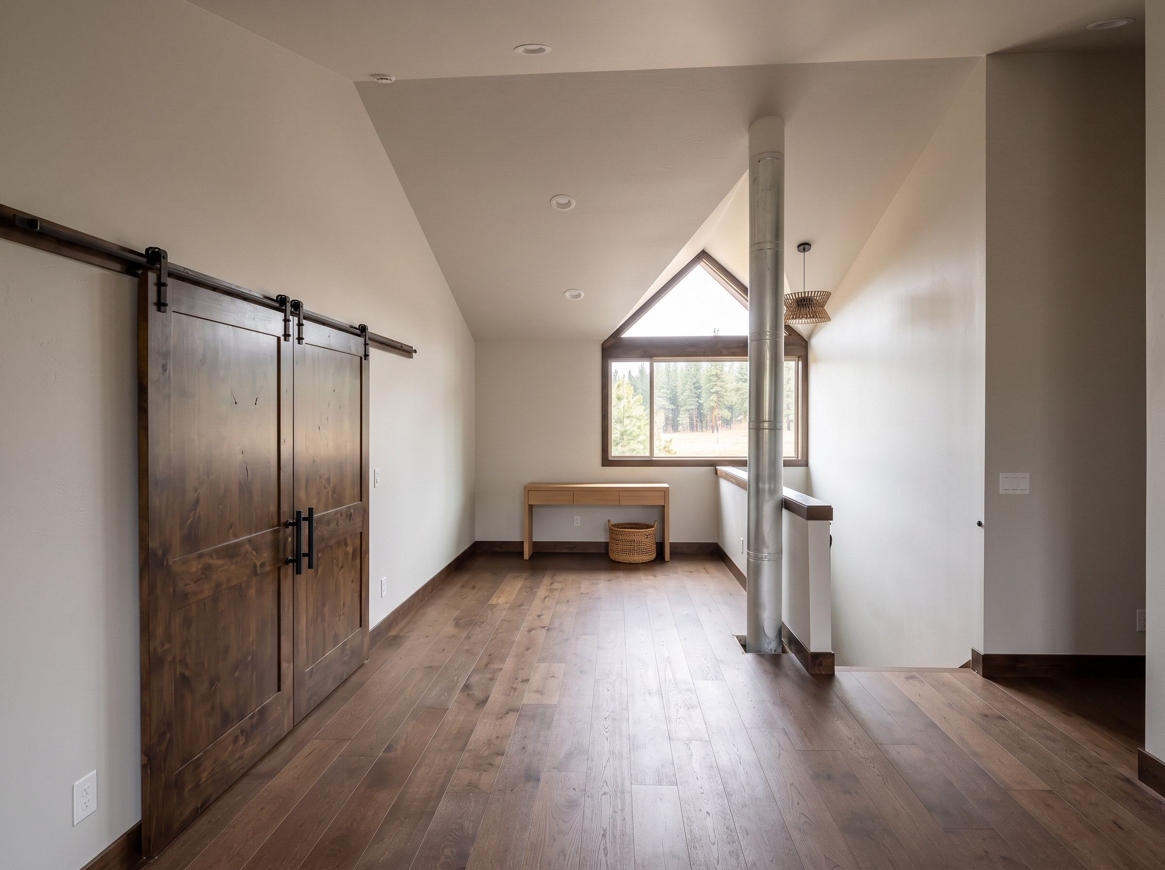 The loft sitting area behind sliding barn doors