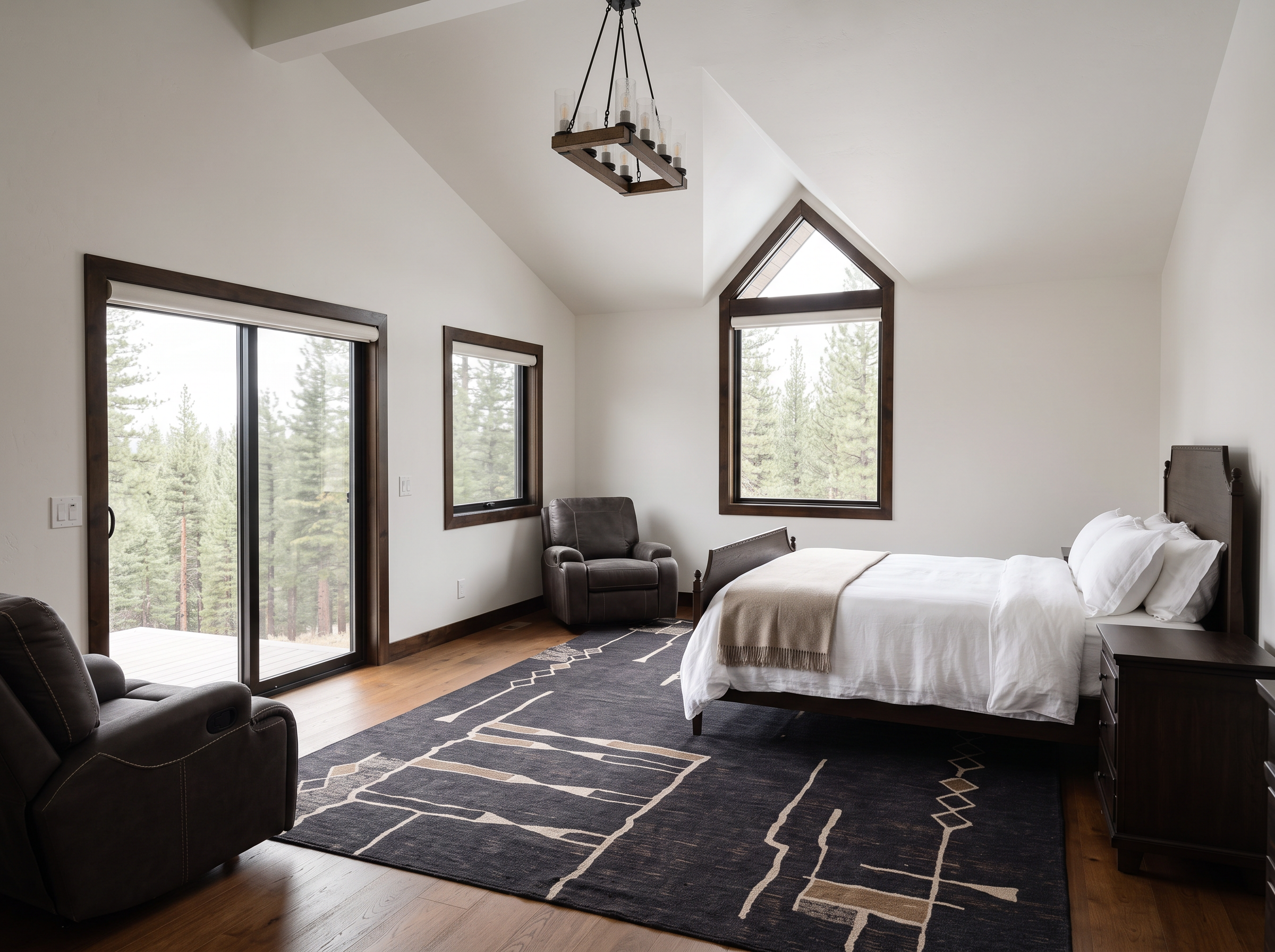 The loft primary bedroom under a vaulted timber ceiling