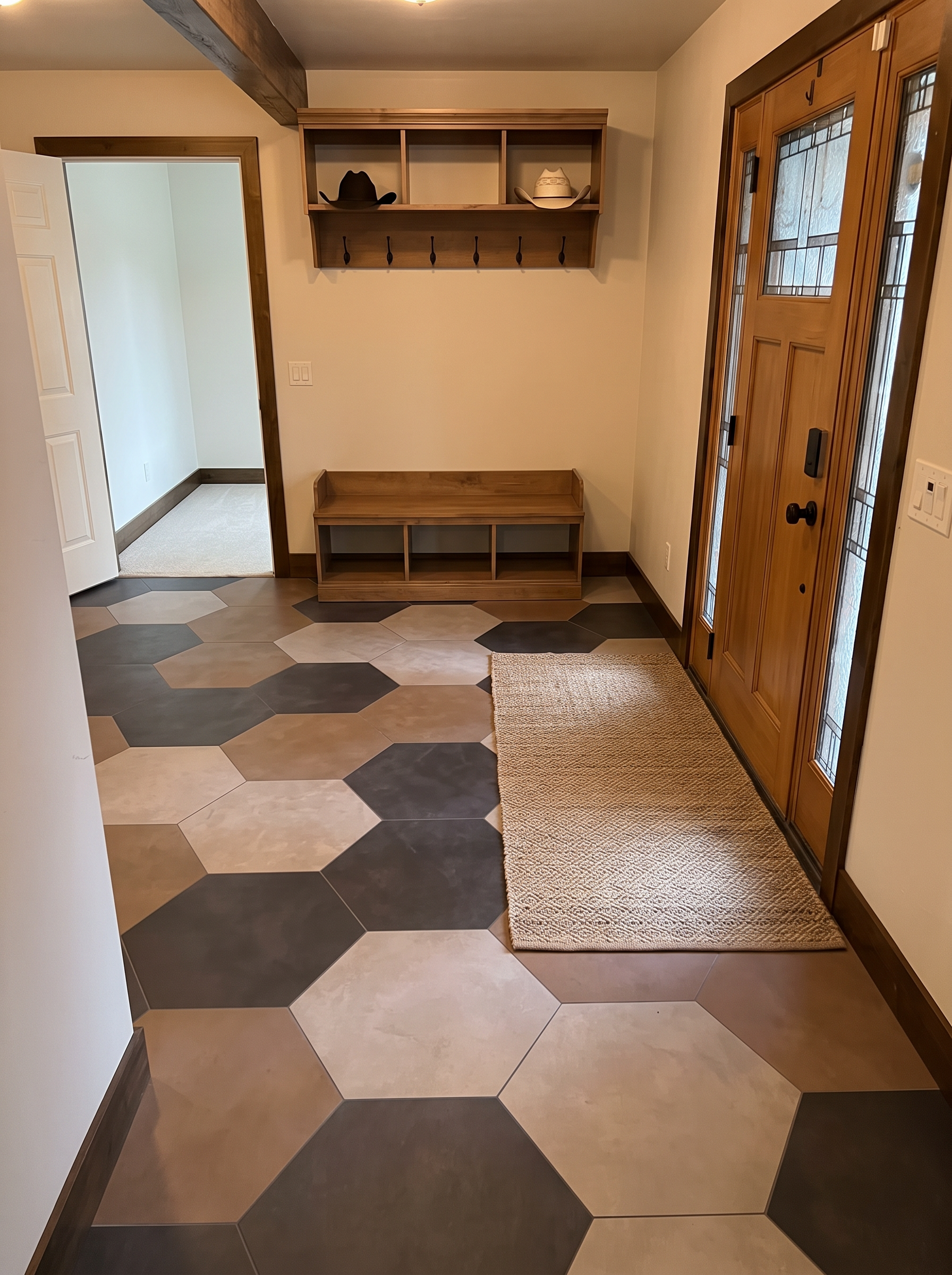 The mudroom with built-in bench and hooks, cleared and calm