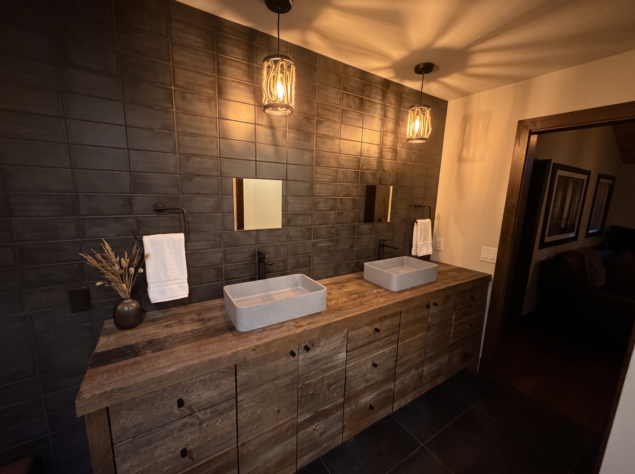 A double vanity of reclaimed barnwood with stone vessel sinks