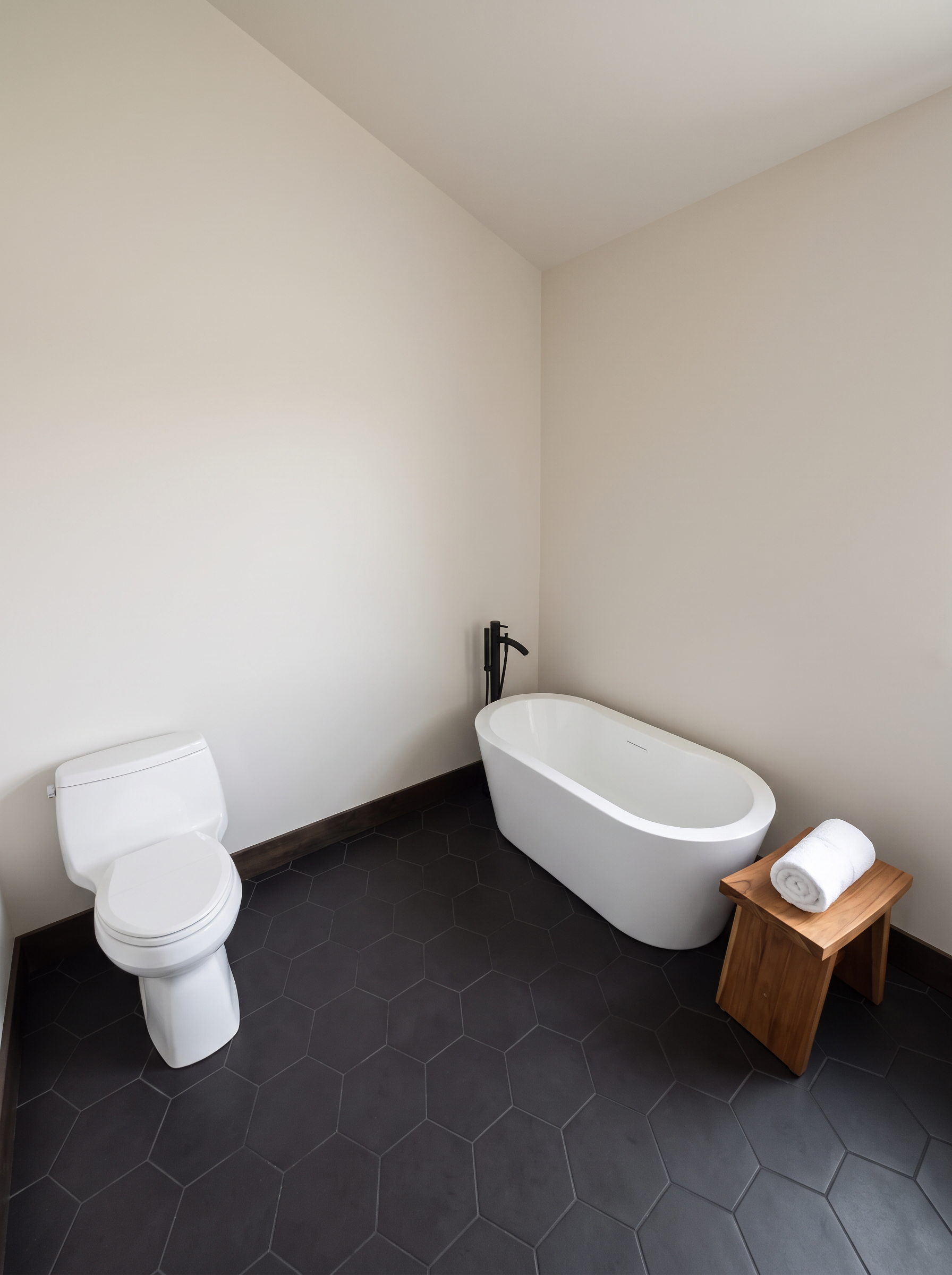 A quiet tub room with tile and daylight