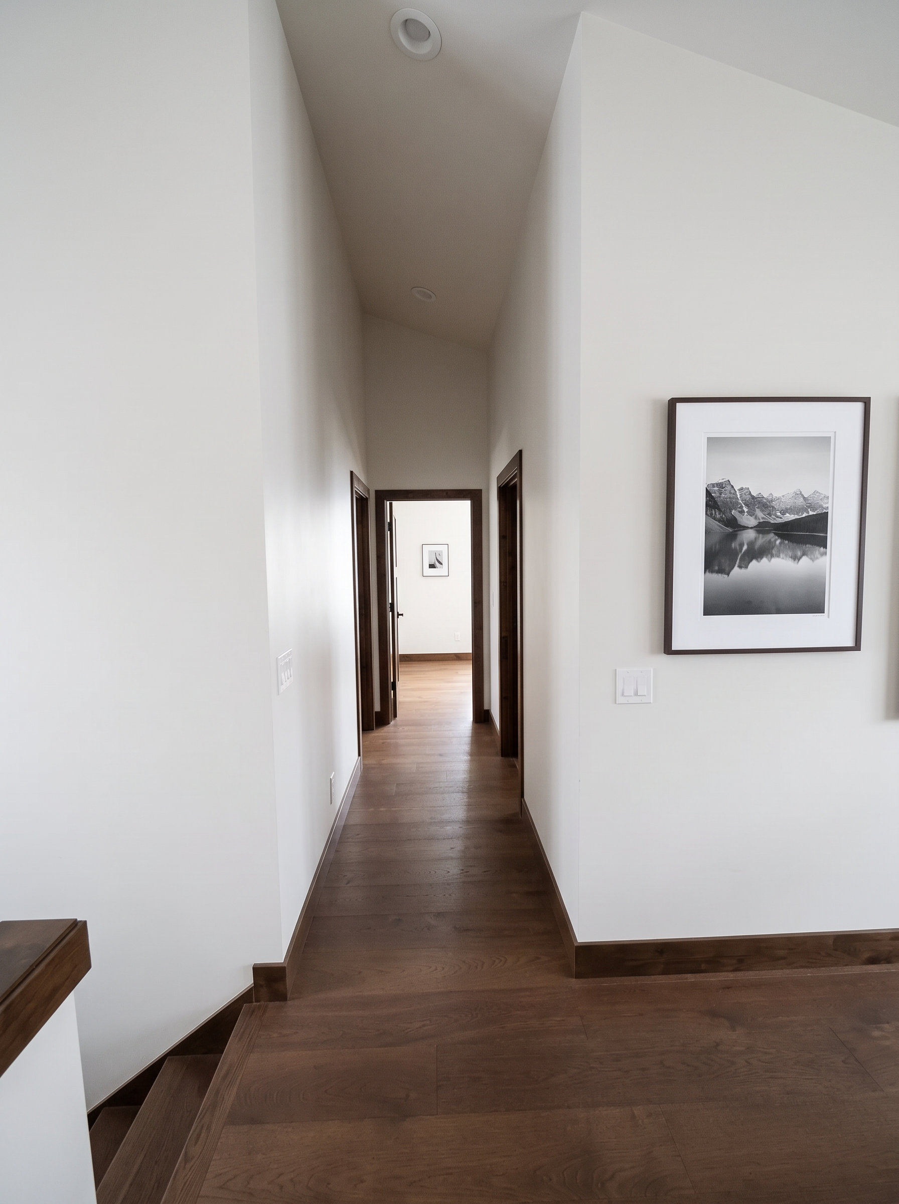 The upstairs hall with timber doors and warm light